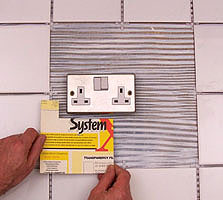 How do you install wall tile around electrical outlets?